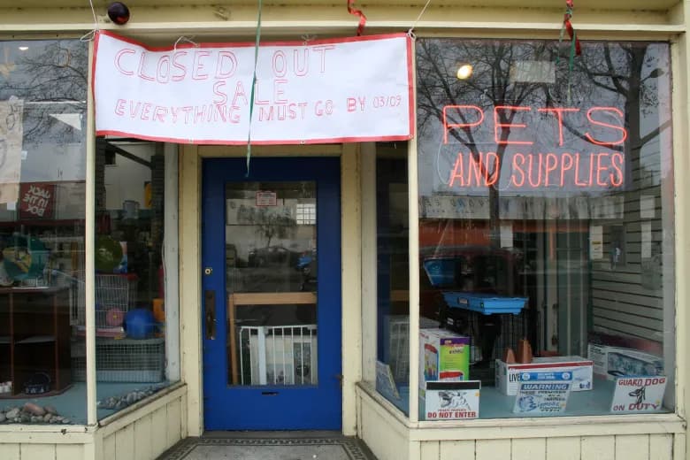 Pet supplies storefront with closed out sale sign